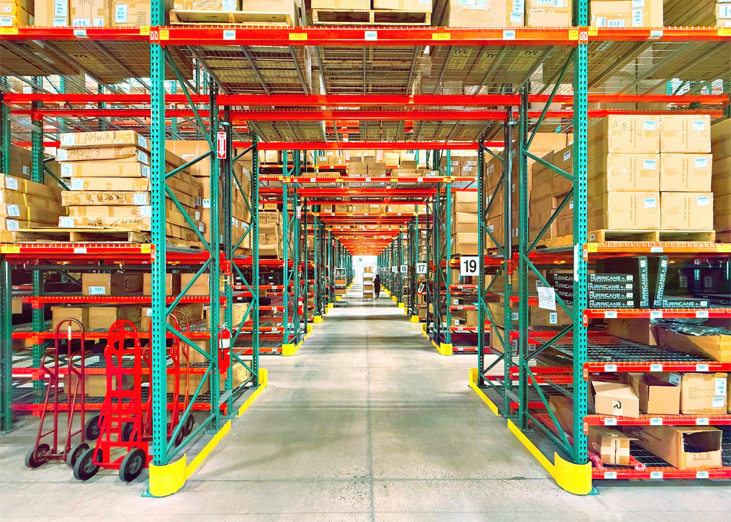 Rows of warehouse shelving stocked with boxes ready for wholesale order fulfillment