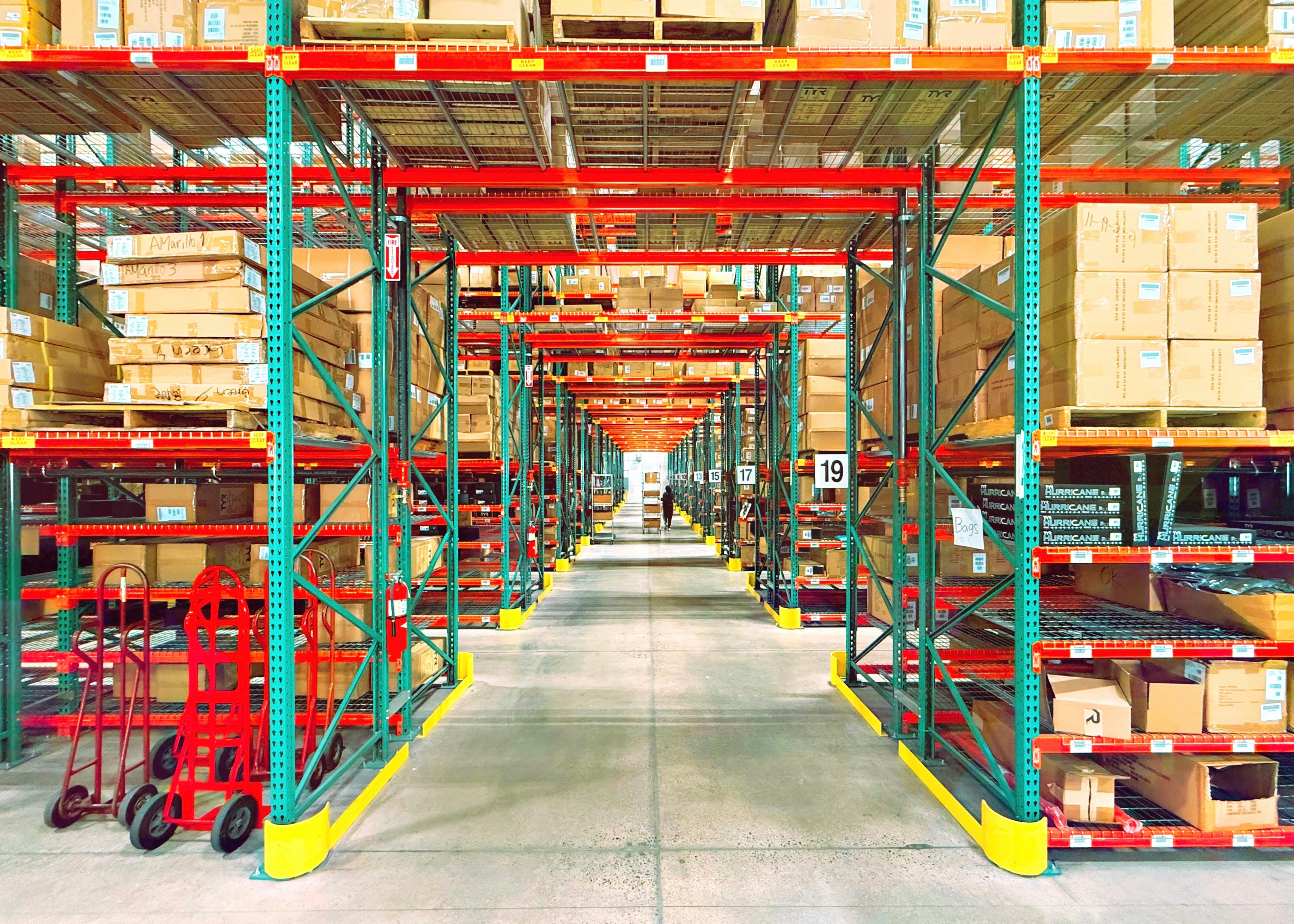 Rows of warehouse shelving stocked with boxes ready for wholesale order fulfillment